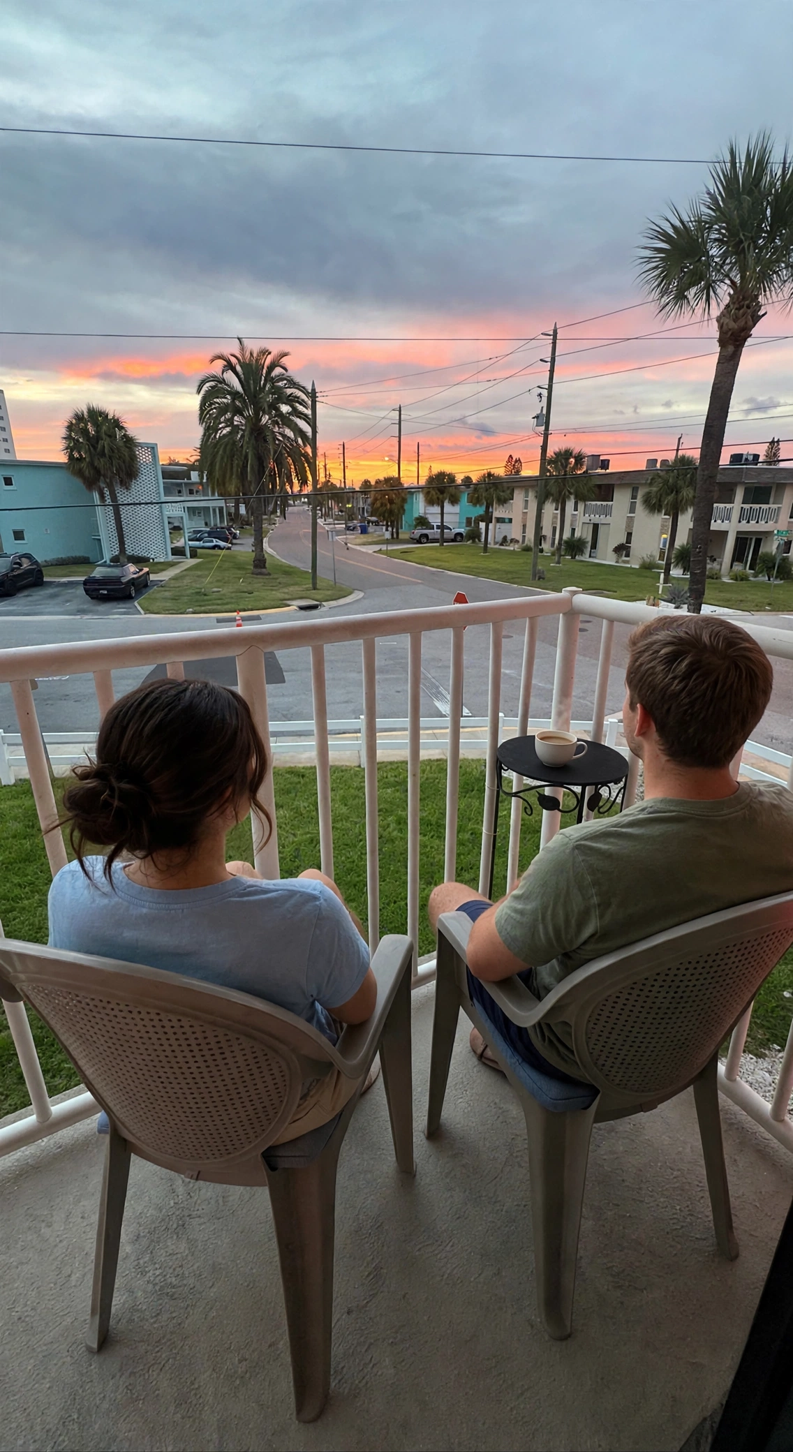 Couple drinking coffee on a private condo balcony at sunset, St. Pete Beach Florida