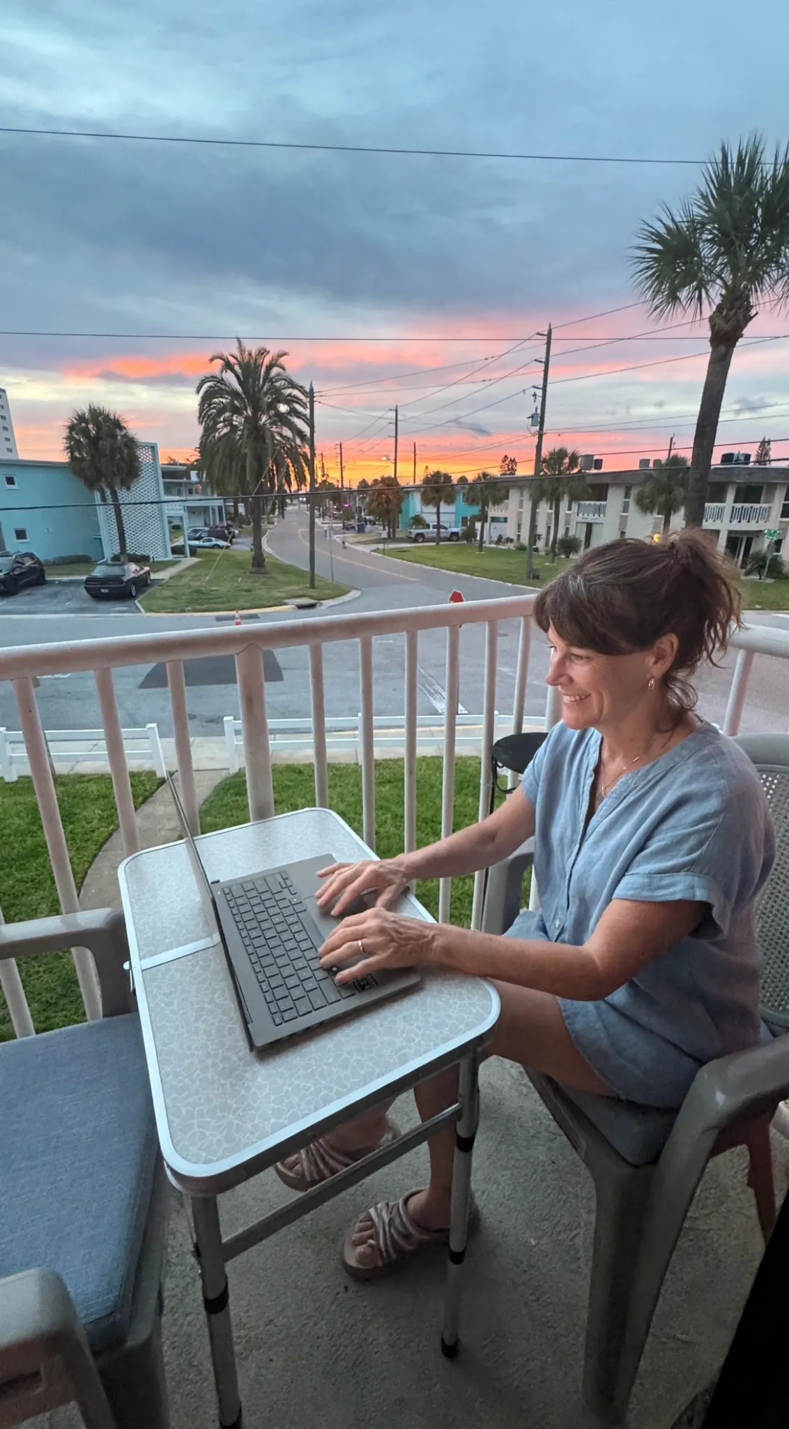 Remote worker using a laptop on a private St. Pete Beach condo balcony